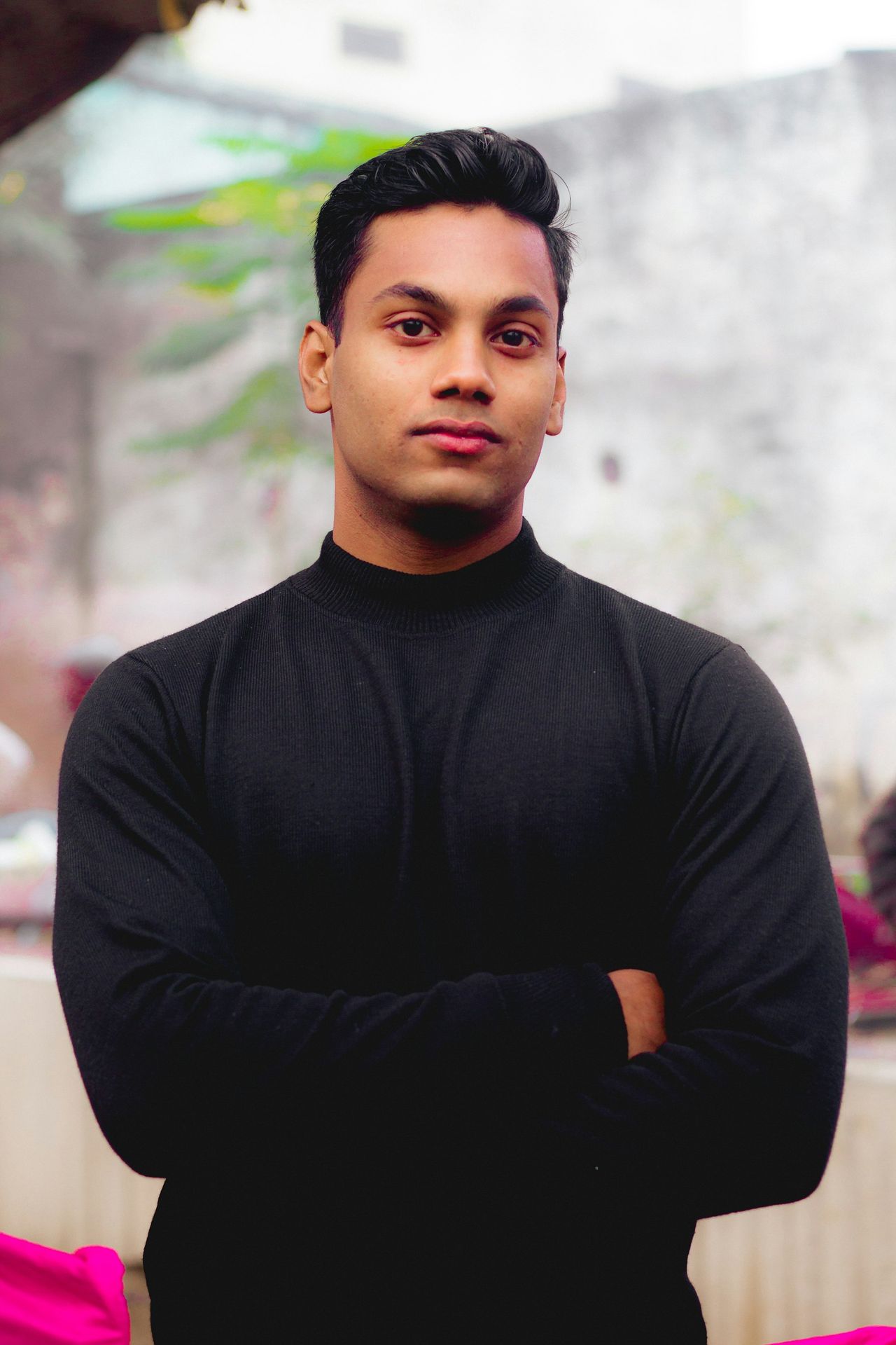 a man standing with his arms crossed in front of him